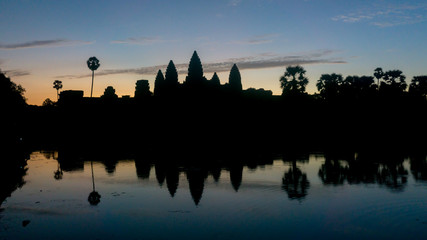 Obraz premium Siem Reap, Cambodia, December 06, 2015: Silhouette of Angkor Wat temple in Cambodia during sunrise. Angkor Wat is one of the famous tourist attraction in the world, located at Cambodia.