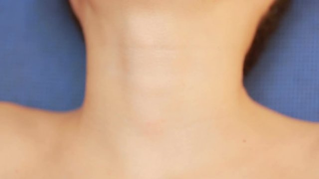 throat close up. Little boy with a sore throat. Holding his neck