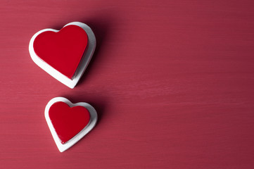 Double red heart on white heart on red grunge background.