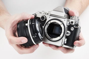 Retro photo SLR camera in hands of photographer closeup