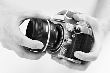 Black and white photo SLR camera in hands of photographer