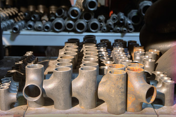 Butt weld equal tee on a shelf in the storage facility.
