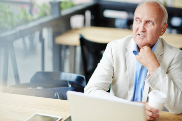 Concerned Mature Businessman in Cafe