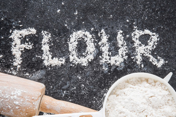 Word flour on the dark background. Healthy eating and lifestyle.