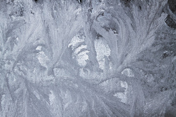 glittering frosty pattern on glass closeup