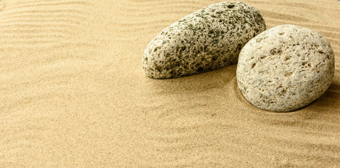 Fototapeta na wymiar Sand and stones. Beach composition with copy space.