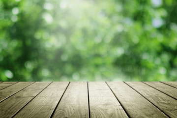 Empty wooden and blur green background.