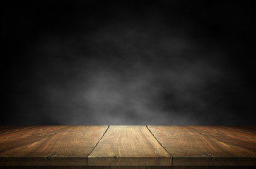 Old wood plank with smoke in the dark background.
