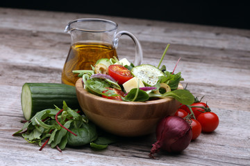 Caprese. Caprese salad. Italian salad. Mediterranean salad. Italian cuisine. Mediterranean cuisine. Tomato mozzarella basil leaves black olives and olive oil on wooden table. Recipe - Ingredients