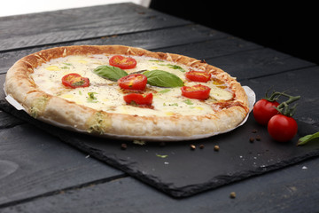 Hot true PEPPERONI ITALIAN PIZZA with salami and cheese. TOP VIEW Tasty traditional pepperoni pizza on board on wooden table with decoration