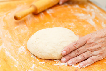 Homemade dough on chopping board