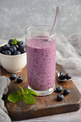 Blueberry and banana smoothie with oatmeal on the rustic wooden table, selective focus, copy space