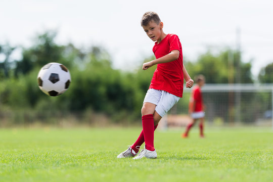 Boy Kicking Soccer Ball