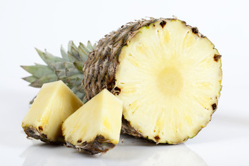 Pineapple with slices on white background