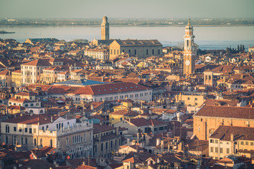 Fototapeta premium Aerial view of Venice, Italy, at sunset with rooftops of buildings and vintage colors in winter afternoon.