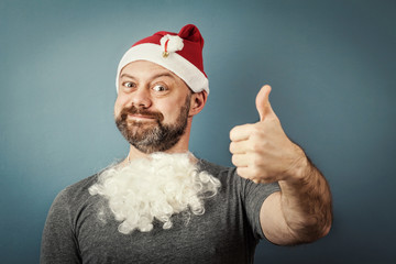 a bearded middle-aged man in a santa hat showing gesture well. t