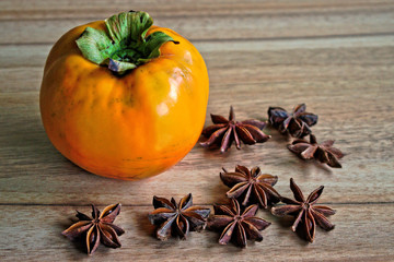 Persimmon and star anise on a wooden table