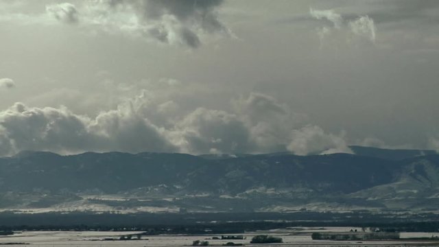 Winter Clouds Rise from Warm Waters of Mountain Reservoir