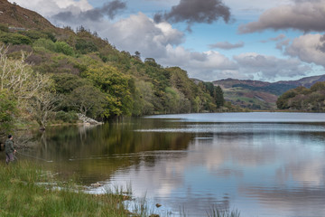 Fototapeta na wymiar calm reflected lake with fly fishing