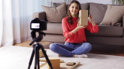 woman with camera recording video at home