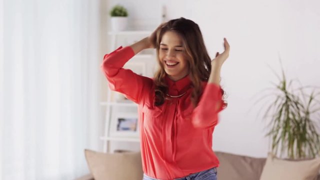 happy young woman dancing at home
