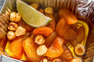 Healthy snack. Dried apricots with hazelnuts in foil box