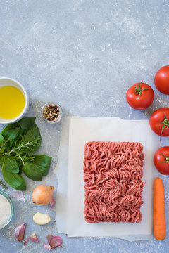 Ingredients for bolognese sauce: ground meat, tomato, carrot, onion, garlic, herbs, seasonings and olive oil