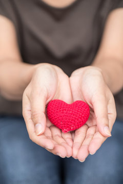Giving Love. Red Heart In Women Her Hand