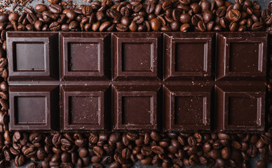 Chocolate and coffee beans .Dark chocolate background. A large bar of chocolate on gray abstract...