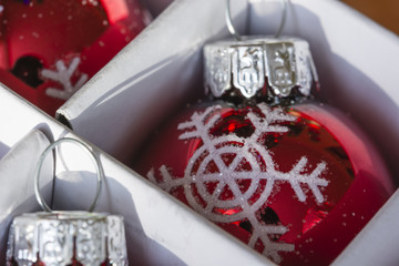 Christmas red bulb in a box with snowflakes.