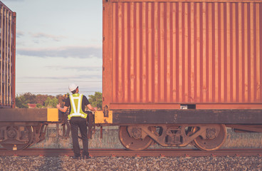 Engineering working  in front of cargo loading workplace, Freight train