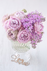 Lovely bunch of flowers .Close-up floral composition with a pink roses on a table. Beautiful bouquet for a birthday or Valentine's Day.Congratulation with a flowers . 