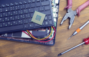 broken laptop and tools
