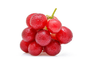 Red grapes with drop of water on white background.
