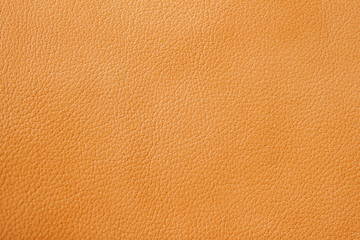 Texture of genuine leather close-up, cowhide, orange, for background , backdrop, substrate use.