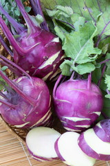Purple kohlrabi cabbage with green leaves