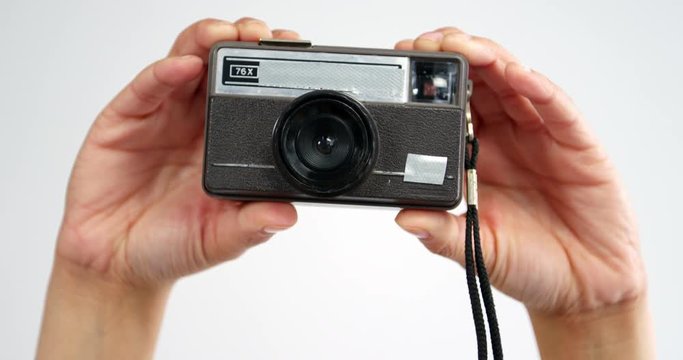 Close-up of photographer taking photo with vintage camera in studio 4k