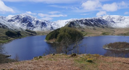 Snow covered mountain range overlooking a beautiful lake