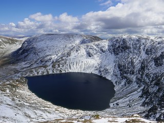 Lake set in snow covered mountain 