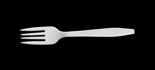 top view of the plastic fork on black background