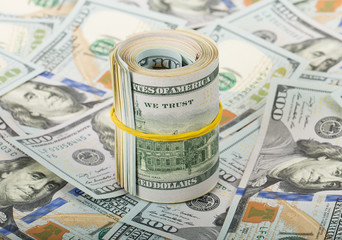 Fototapeta premium dollars in roll on money background