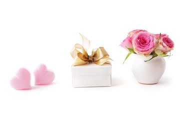 gift, flowers and pink hearts isolated on white