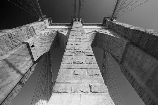 Fototapeta Brooklyn Bridge pillar low angle view, New York in black and white