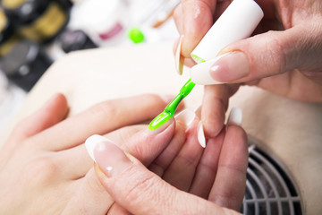 Obraz na płótnie Canvas Manicure specialist care by finger nail in beauty salon.