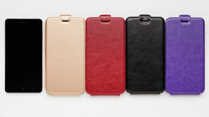 Set of color leather cases for smartphone on a white background