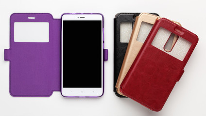 Set of color leather cases with a window for the smartphone on a white background