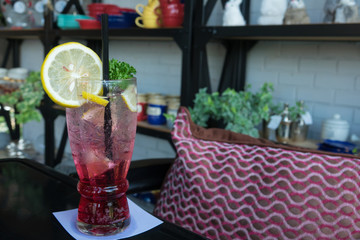 Homemade fresh pink lemonade with lemon, lime and strawberries