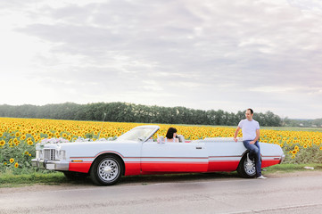 beautiful couple in love with the car