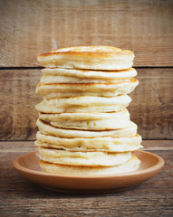 stack of pancakes on a wooden background