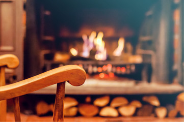 Home comfort. Rocking chair near the fireplace. Photo of interior